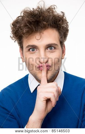 Handsome man making silence gesture, shhhhh!!