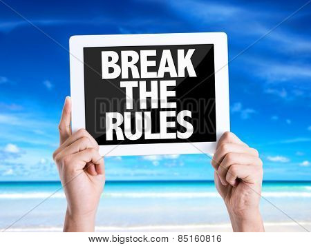 Tablet pc with text Break the Rules with beach background