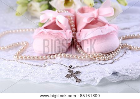 Baby shoe, flowers and cross for Christening