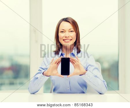 business, office, school and education concept - smiling businesswoman with black blank smartphone screen in office
