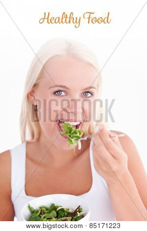 The word healthy food against gorgeous woman eating salad