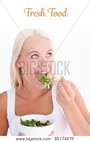 The word fresh food against charming woman eating salad