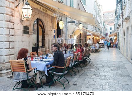 DUBROVNIK, CROATIA - MAY 28, 2014: Guests sitting at Proto restaurant terrace, one of Dubrovnik's best known places for fish specialities.
