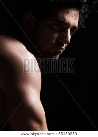 handsome  sexy topless macho man portrait topless muscular in studio black background