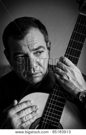 Man with a guitar. Black and white portrait