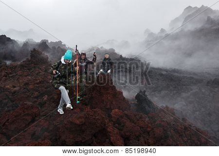 Tourists Hiking On Lava Field Eruption Active Tolbachik Volcano On Kamchatka Peninsula. Russia