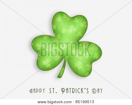 Shiny Irish lucky shamrock leaf on grey background for Happy St. Patrick's Day celebration.