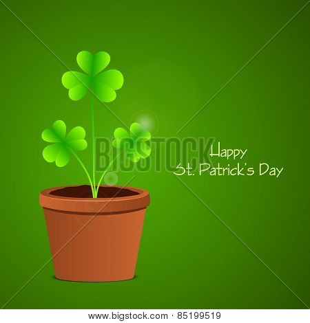 Elegant greeting card design with glossy shamrock leaves in a pot on green background for Happy St. Patrick's Day celebration.
