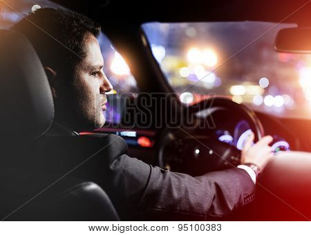 Man Driving A Car At Night