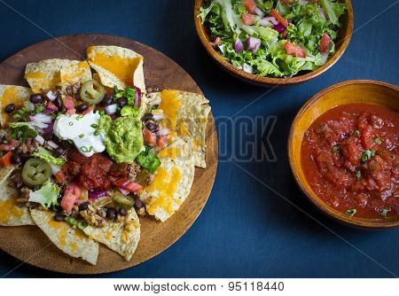 Homemade Nachos with tortilla chips cheese and guacamole,