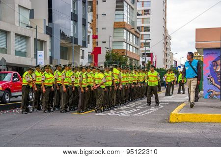 Policemen waiting for Pope Francis Popemobile motorcade comming as his first oficial visit  to Quito