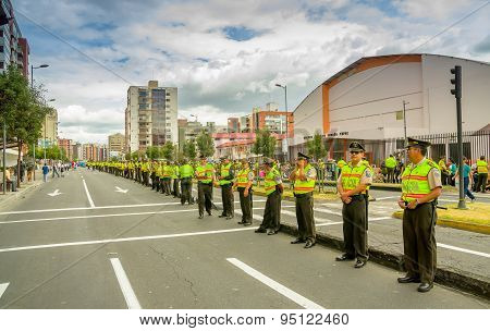 Long line police officers guarding the street as crowds await arrival of Pope Francis motorcade in r