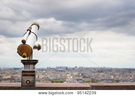 Telescope viewer and city skyline at daytime.