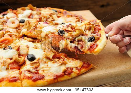 Al Funghi Pizza Cut In Sectors With One Piece Taken In Hand