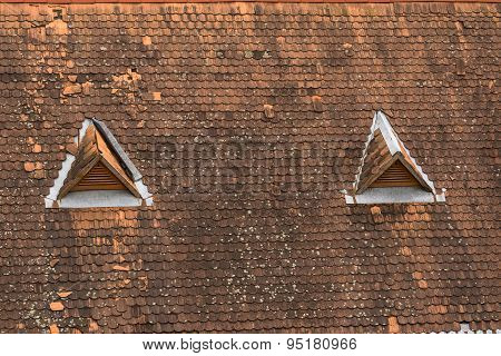 Old house top with traditional roof and little windows