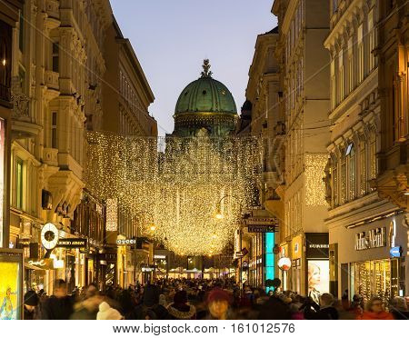 VIENNA AUSTRIA - 2ND DECEMBER 2016: A view along Kohlmarkt in Vienna at Christmas. Lots of people decorations and the outside of shops can be seen.