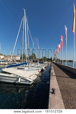 BARDOLINO, ITALY - MAY 4, 2016: Sailboats and fishing boats at Porto di Bardolino harbor on The Garda Lake . Italy