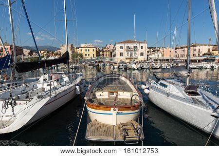 BARDOLINO, ITALY - MAY 4, 2016: Sailboats and fishing boats at Porto di Bardolino harbor on The Garda Lake . Italy