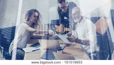 Double exposure concept.Young team of business partners making great discussion in modern coworking studio.Bearded businessman man talking with colleagues about strategy.Horizontal, blurred background