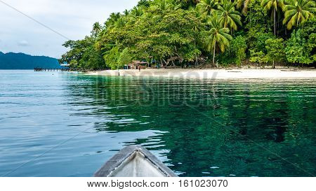 Boat approaching local Village on Friwen Island, West Papuan, Raja Ampat. Indonesia
