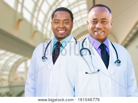 Two Handsome African American Male Doctors Inside Hospital Office.