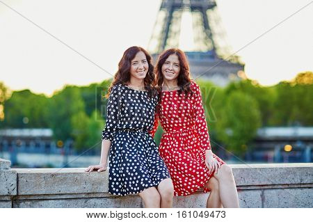 Beautiful Twin Sisters In Front Of The Eiffel Tower In Paris