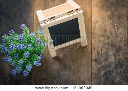 Black Board And Violet Flower On Weeden Background