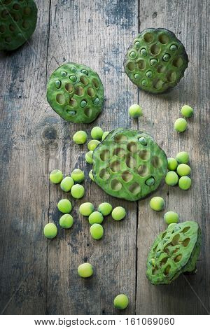 Lotus seeds and calyx on wooden background
