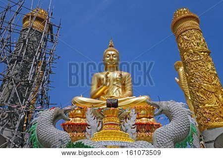 a golden big buddha thailand style statue