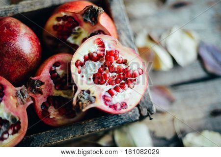 Ripe Pomegranate Fruit On Wooden Vintage Background. Red Juice P