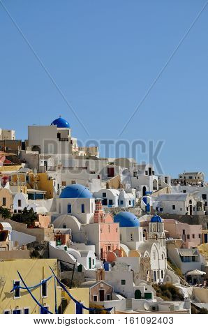 white houses and church domes on Santorini at sunrise, Greece.