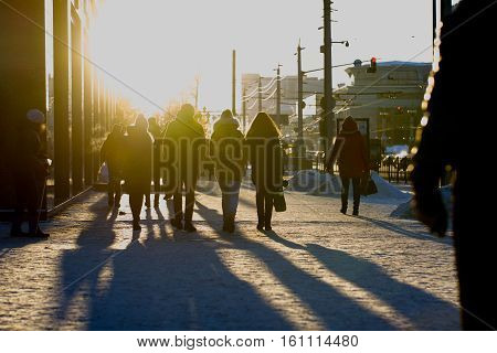 Crowded street at winter cold sunsed, blurred background, telephoto