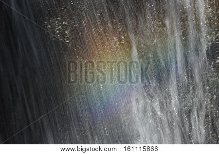 Rainbow at the waterfall Millomeris in the mountains in Cyprus