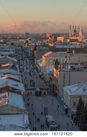 KAZAN, RUSSIA - DECEMBER 11, 2016: center of Kazan - old orthodox church, kremlin, mosque Kull Shariff, Bauman street. Winter sunset telephoto