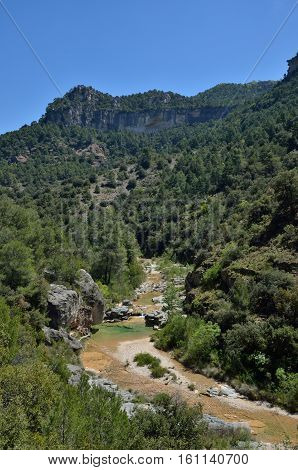 The River Embalsa Is Flowing In The Green Valley Of The Prades Mountains. This Is A Large Calcareous