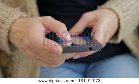 Close-up woman hands using smartphone - scrolling and touching