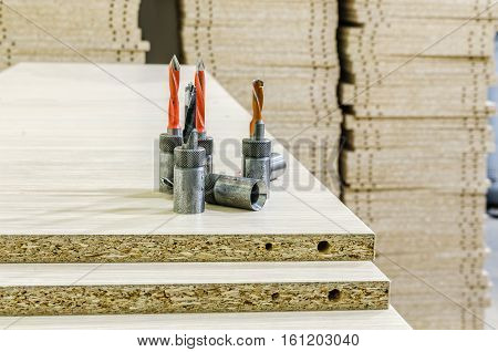 Details for the manufacture of furniture chipboard drilling in stacks