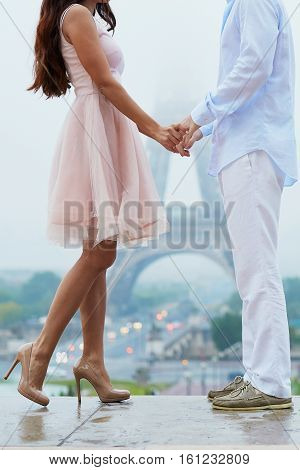 Unrecognizable Couple In Front Of The Eiffel Tower In Paris