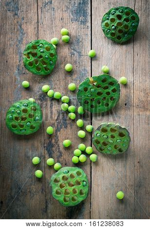 Lotus seeds and calyx on wooden background