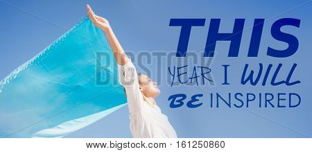 3D this year i will be inspired against woman standing with arms outstretched on beach