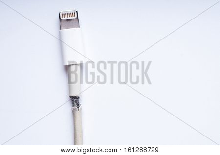 Closeup the Broken Smart Phone Charger Cable on white Background.