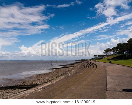 Seafront and dramatic sky and clouds in the Solway Firth at Silloth in Cumbria.