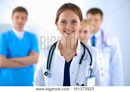 Attractive female doctor in front of medical group .
