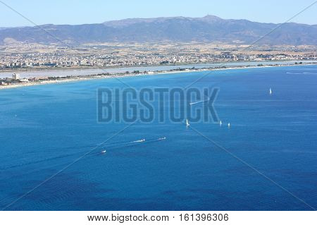 Beautiful aerial view on the city and Golf of Cagliari with white boats and the beach il Poetto in Sardinia Italy.