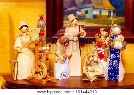 folk style traditional handmade figures made from natural materials doing chores and crafts