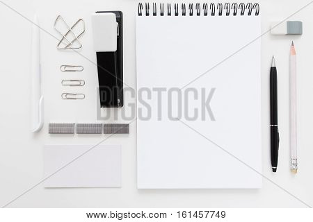 Black and white stationery set free space flat lay. Top view on white desk with office supplies, mockup. Business, worktools, education, accessories concept