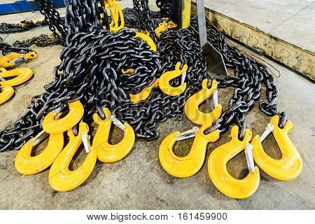 New chain cargo sling. Black steel chain and yellow cargo hooks.