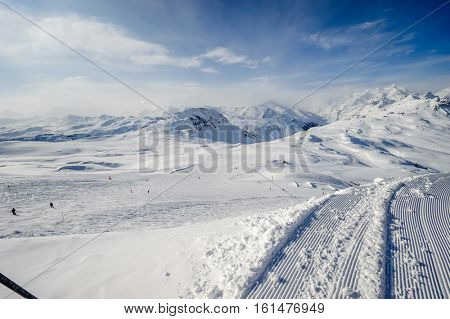 Alpine winter mountain landscape. French Alps covered with snow in sunny day. Val-d'Isere, France