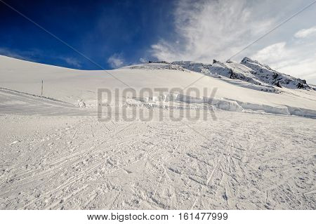 Alpine winter mountain landscape. French Alps covered with snow in sunny day. Val-d'Isere, France