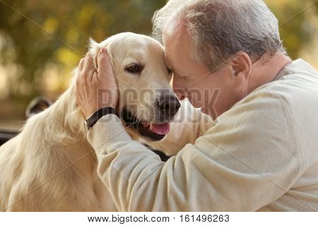 Senior man and big dog, closeup